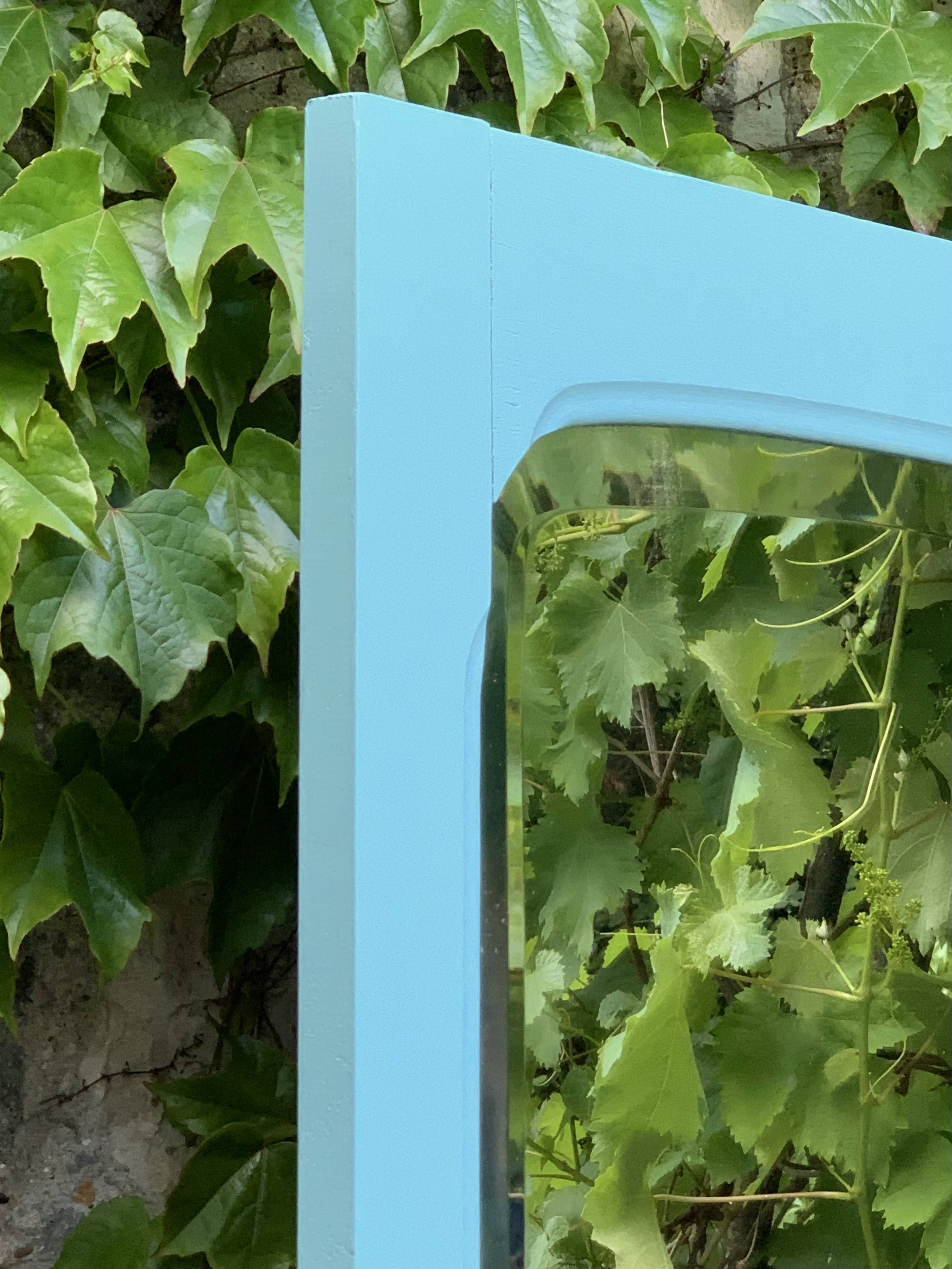 Beveled mirror on turquoise Parisian door