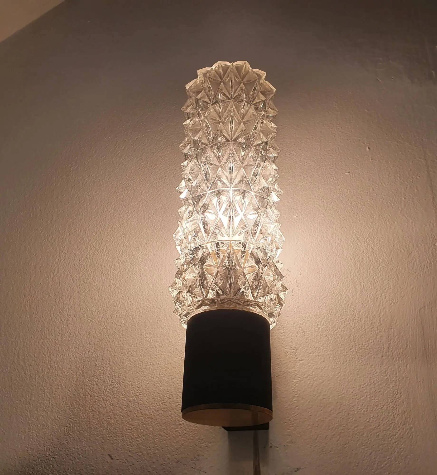 Black wall light with structured glass in Arlus style