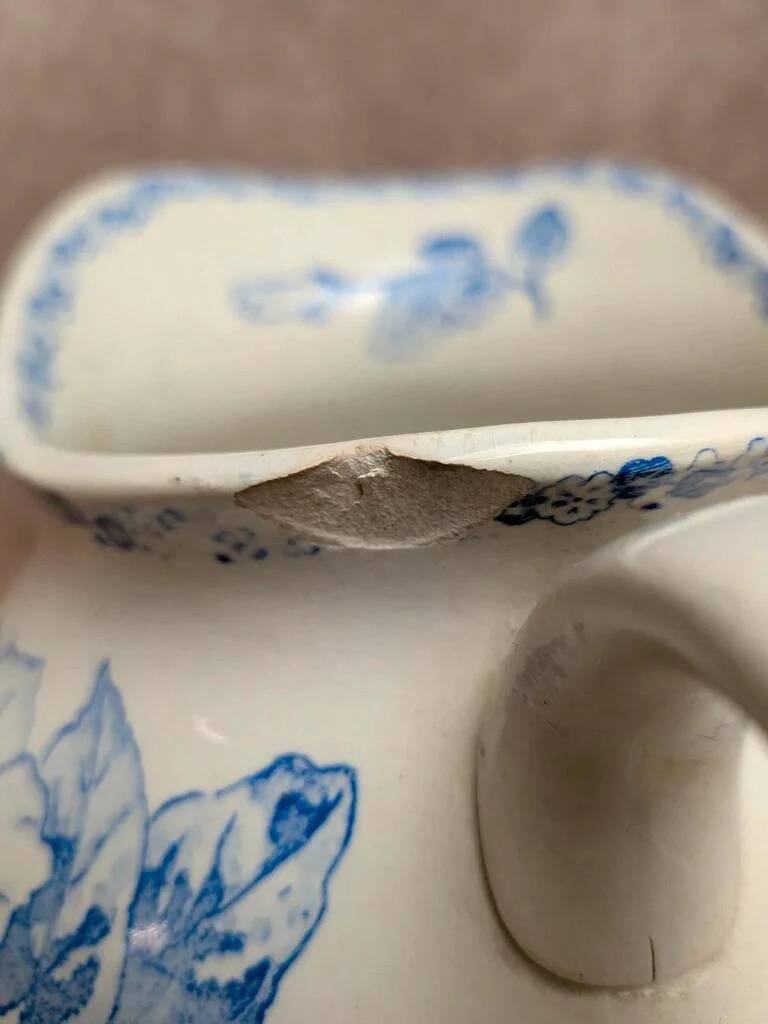 Small antique ironstone jug L.m Creil and Montereau with blue floral decoration.