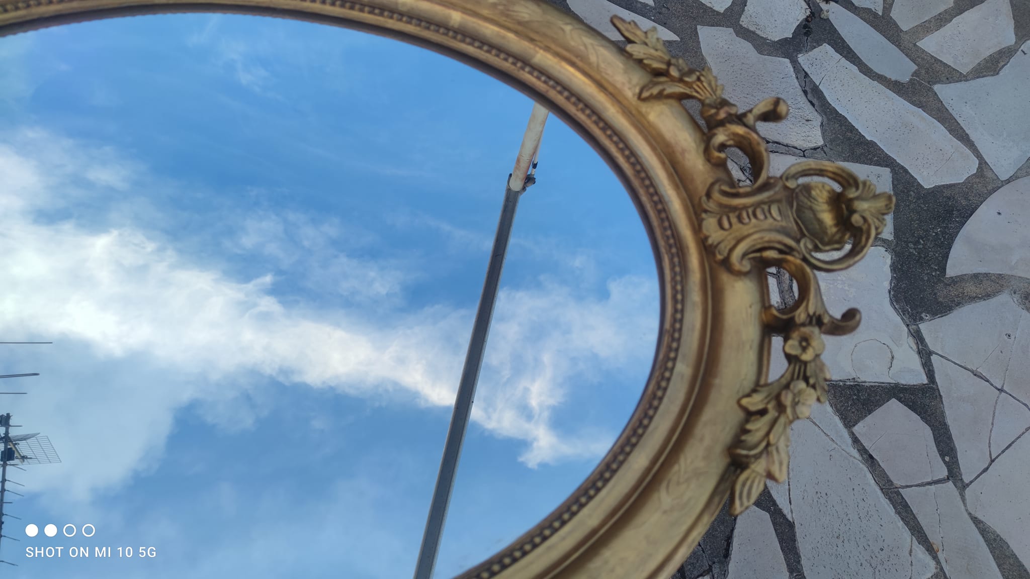 Ovoid mirror with double gilt pediments, circa 1830, 105x66 cm