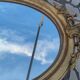 Ovoid mirror with double gilt pediments, circa 1830, 105x66 cm