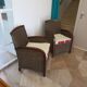 2 armchairs in woven rattan and wood, 1980s