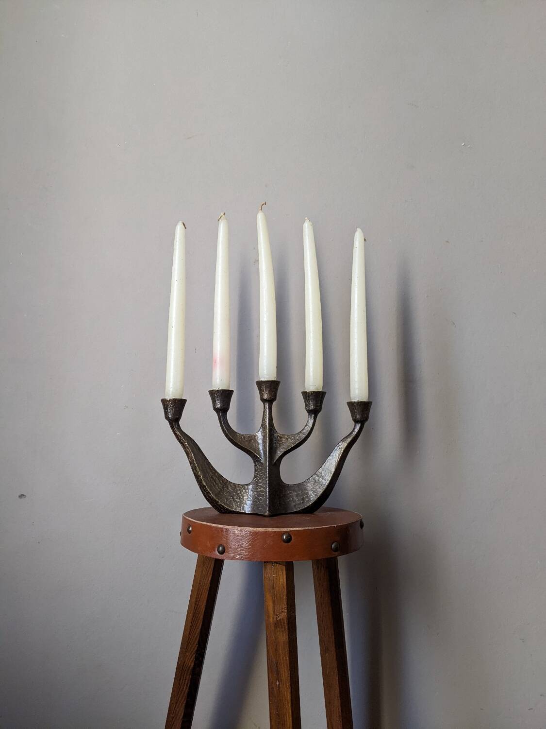 Vintage bronze candlestick chandelier in contemporary Scandinavian design.