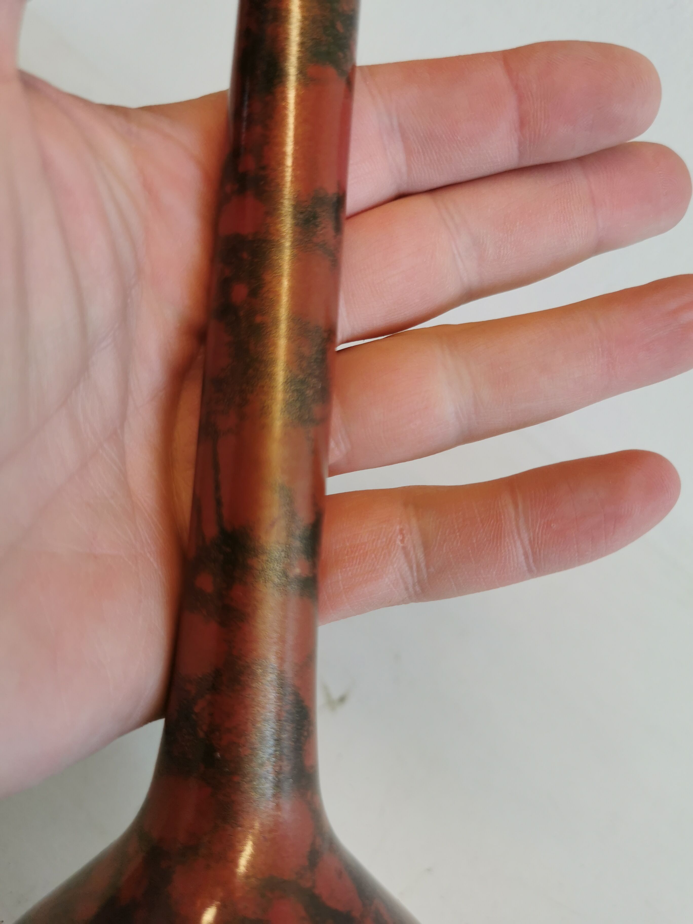 Slim vase with metallic finish.