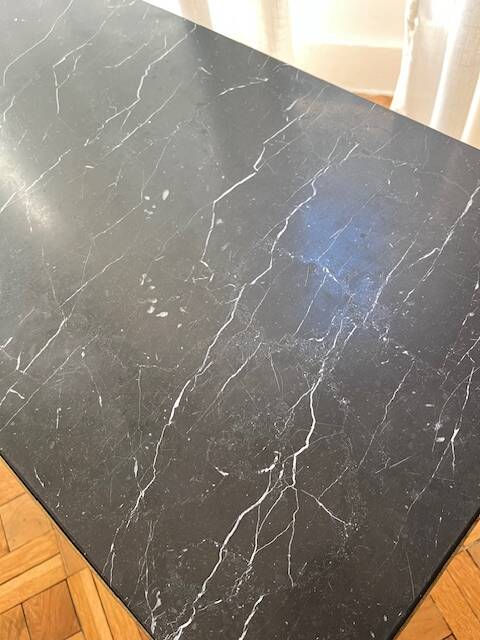 Black marble coffee table with brass legs.