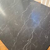 Black marble coffee table with brass legs.