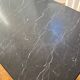 Black marble coffee table with brass legs.