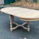 Extendable round farmhouse dining table restored in solid oak from the 19th century