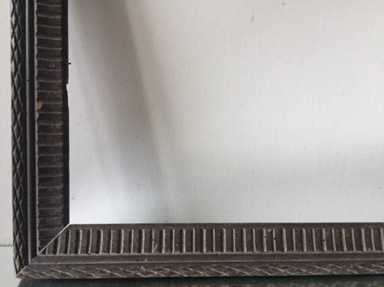 Antique wooden frame with geometric carvings light distress