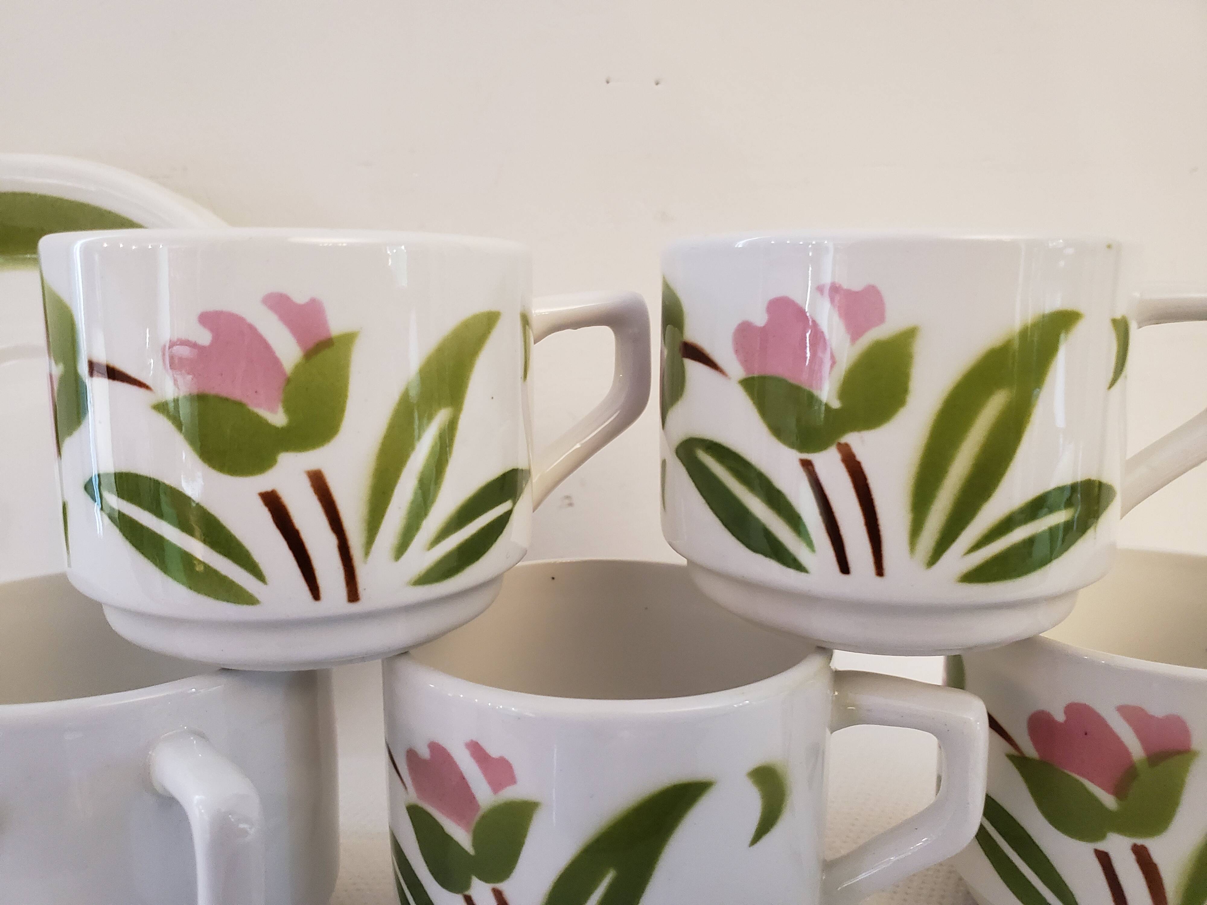 5 cups and ceramic saucers