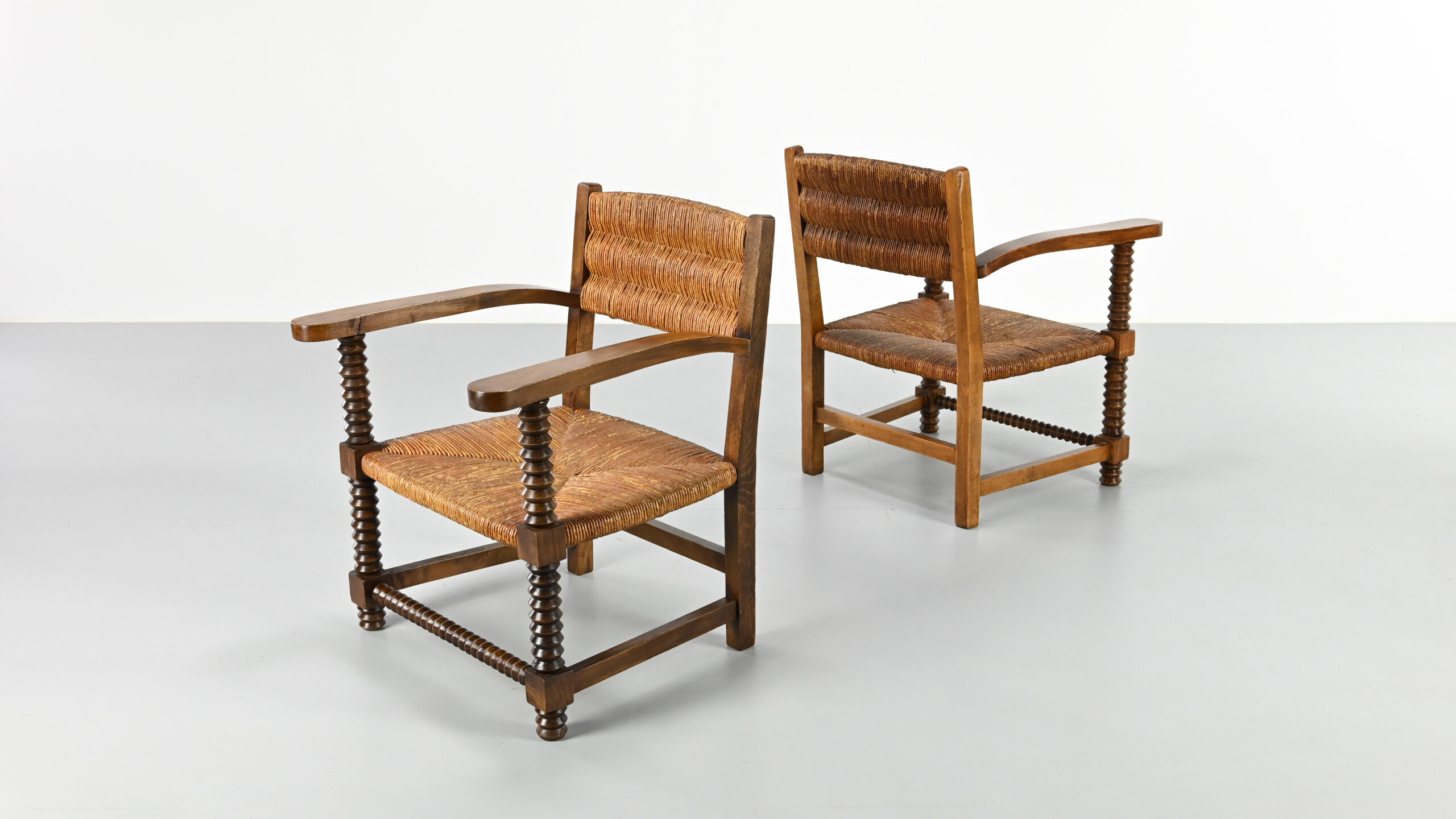 Pair of French armchairs with twisted legs in the style of Charles Dudouyt, France, 1940s.