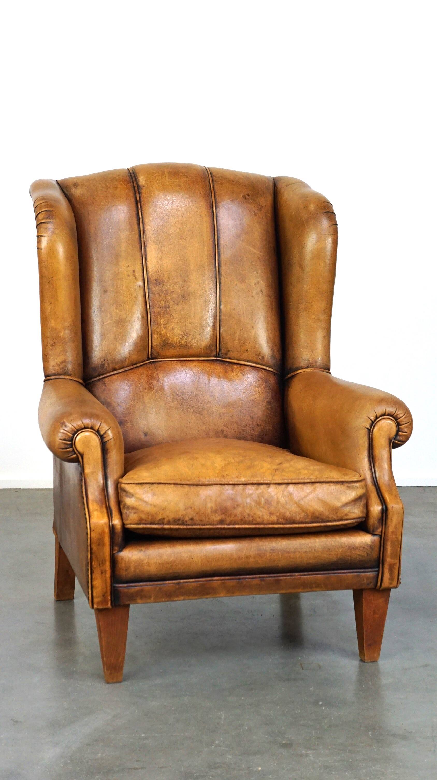 Sheepskin wingback chair with a unique design and a beautiful patina