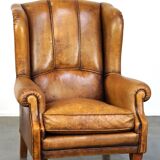 Sheepskin wingback chair with a unique design and a beautiful patina
