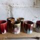 Six old yoghurt pots in enamelled porcelain