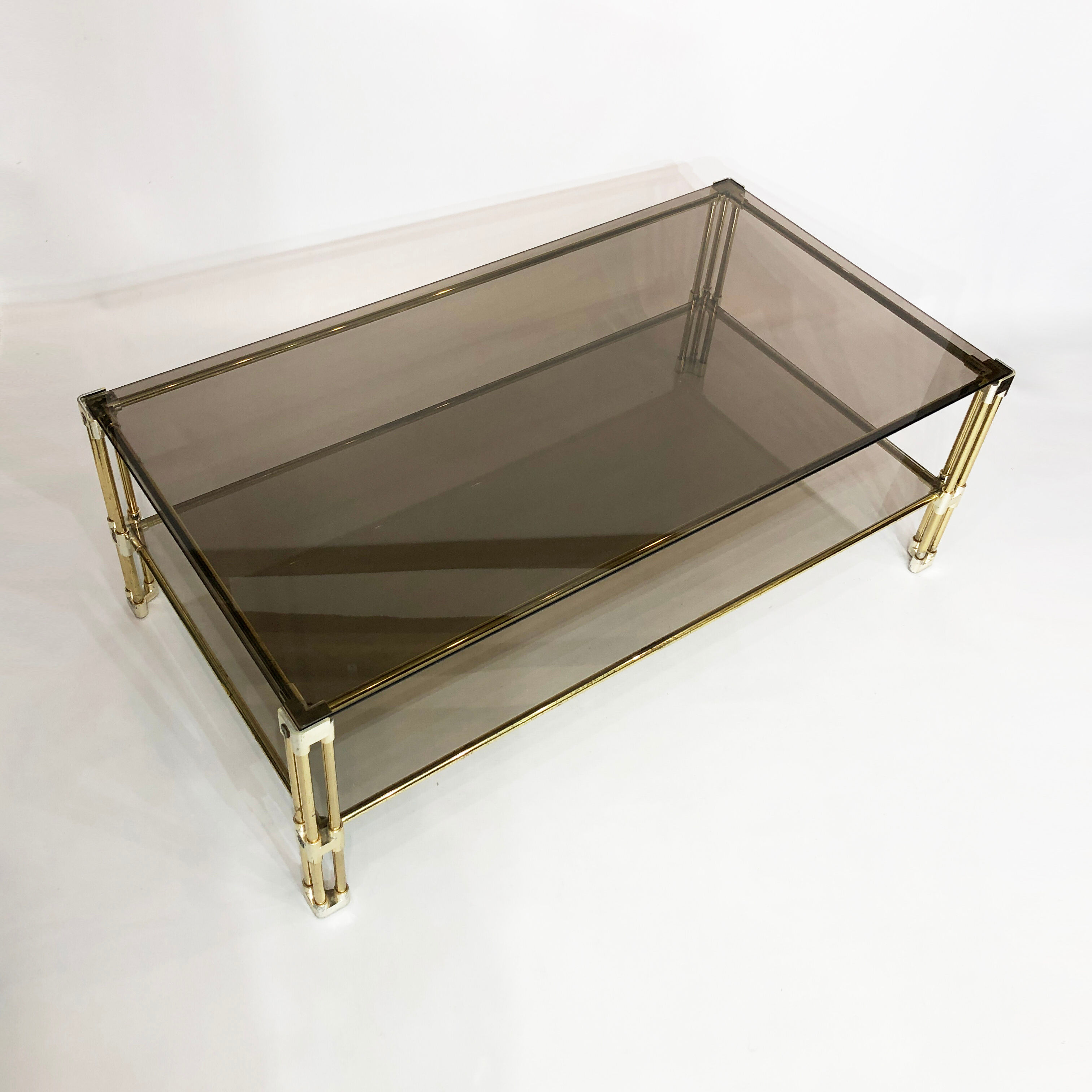 Brass two-tiered coffee table hollywood regency gold smoked glass 1970s