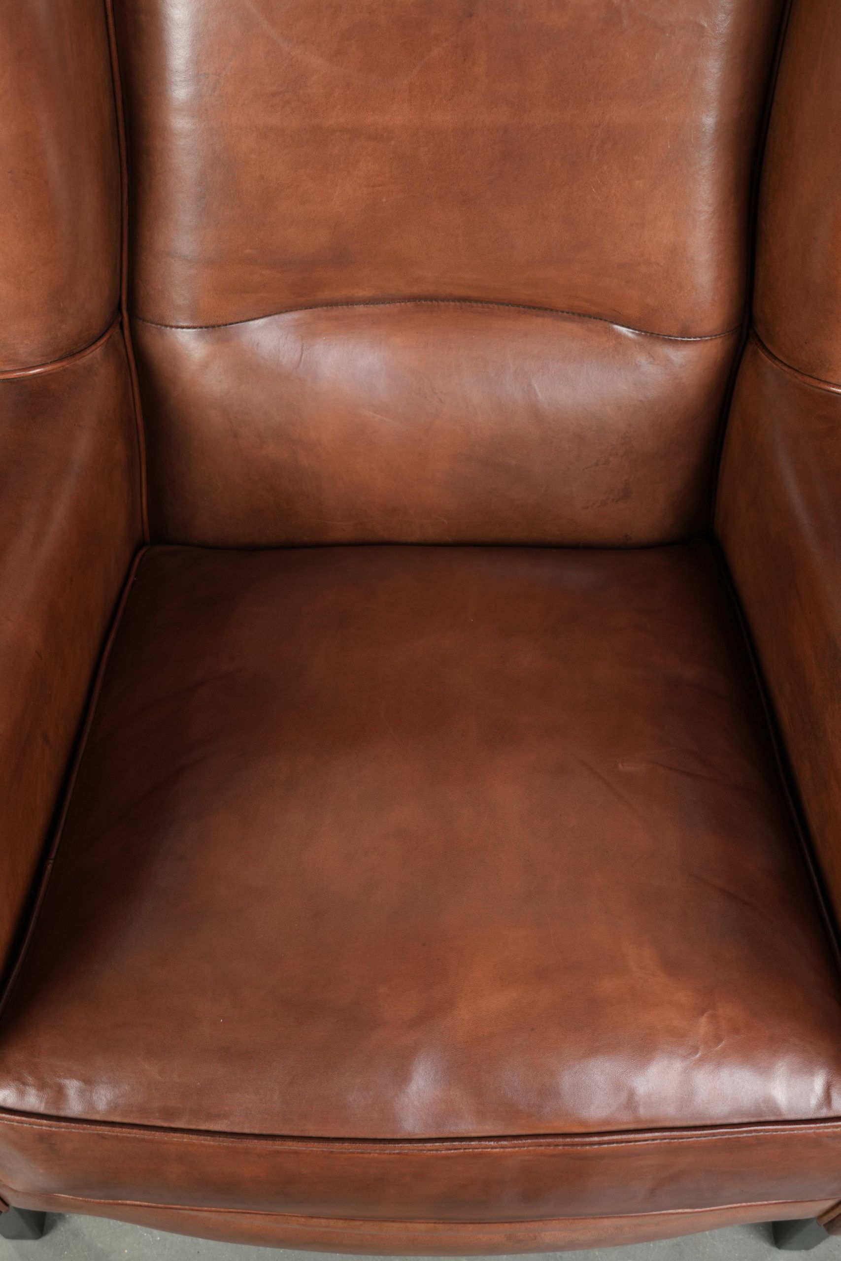 Large sheepskin wingback armchair in timeless English style
