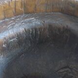 Antique hand carved mortar coffee table with circular glass top