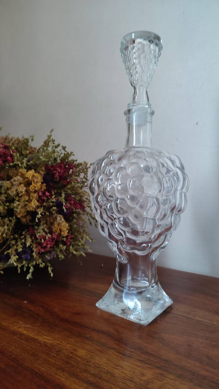 Pressed glass carafe in the shape of a bunch of grapes.
