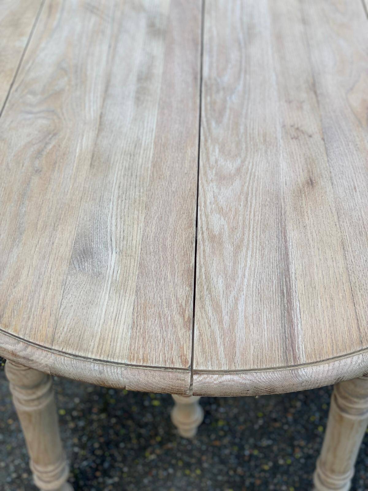 Renovated Louis Philippe round extendable dining table with 4 leaves.