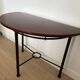 Half-moon console grange in solid cherry wood and wrought iron with a glass top.