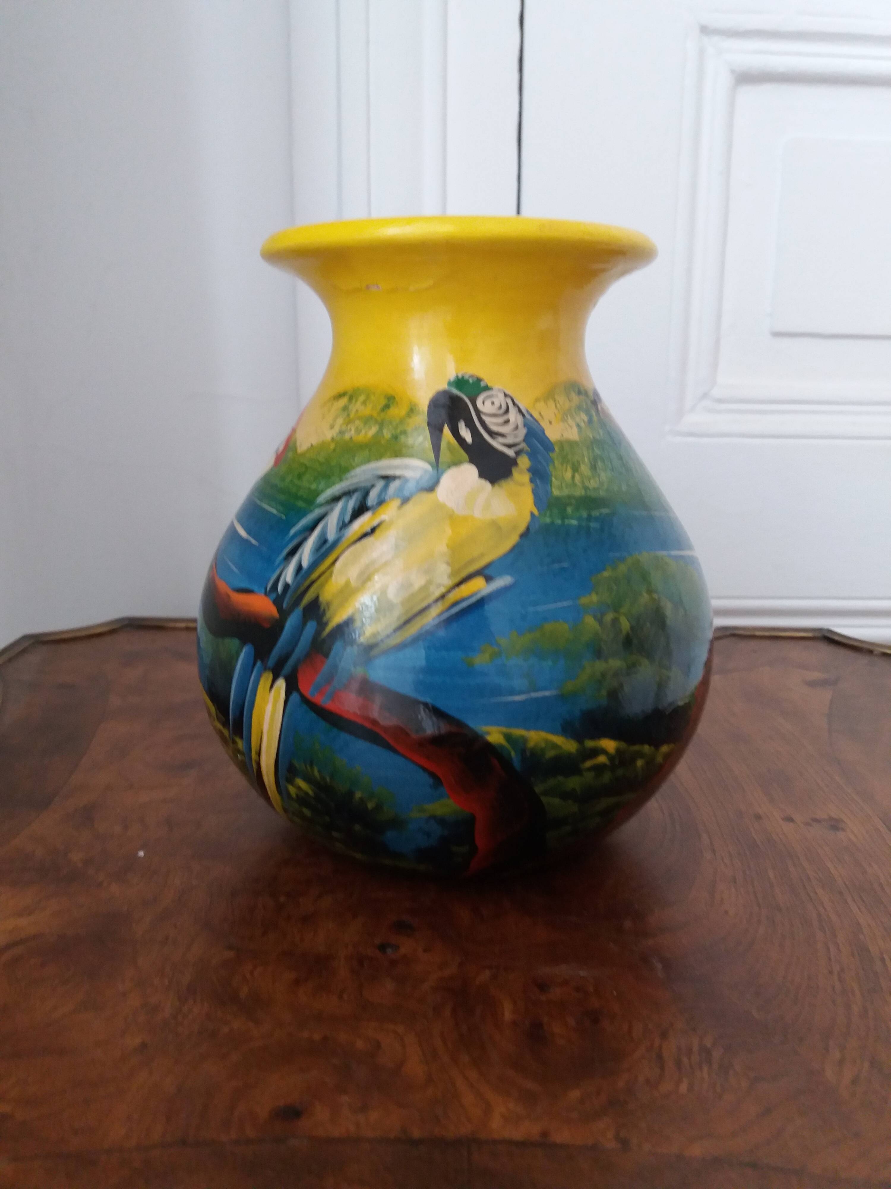 Mexican popular art vase decorated with parrots and toucans.