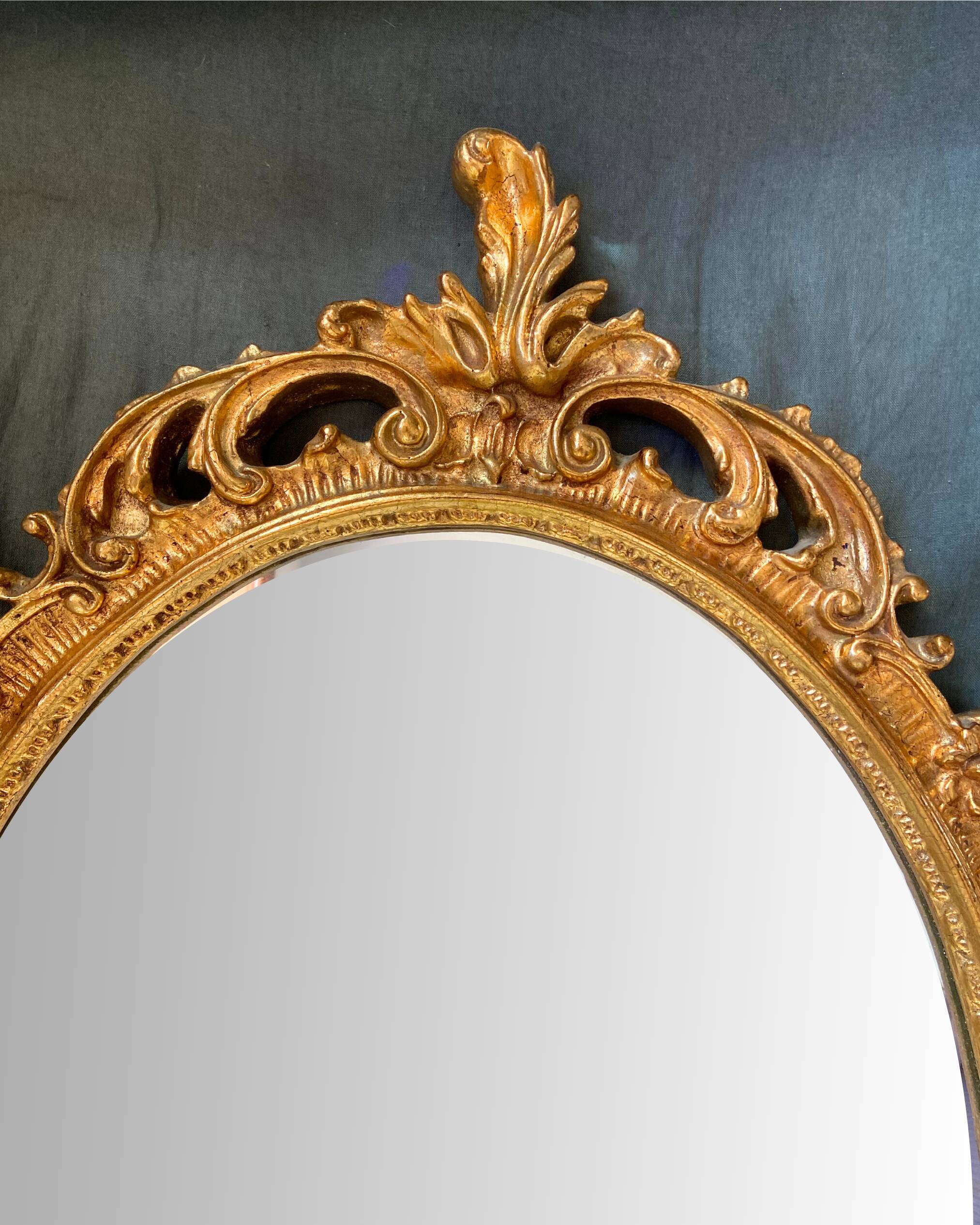 Beautiful Baroque Style Oval Decorative Mirror - Gilded with gold leaf with a Beautiful Patina