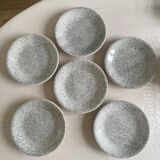 12 speckled ceramic plates.