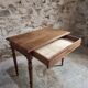 Antique French writing table in walnut with a drawer, circa 1900.
