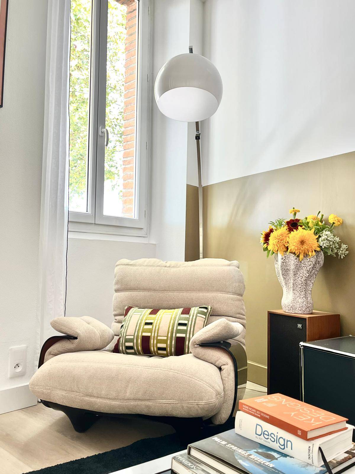 Marsala armchair and its light beige Ligne Roset footrest.