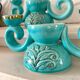 Pair of turquoise and gold double candlesticks