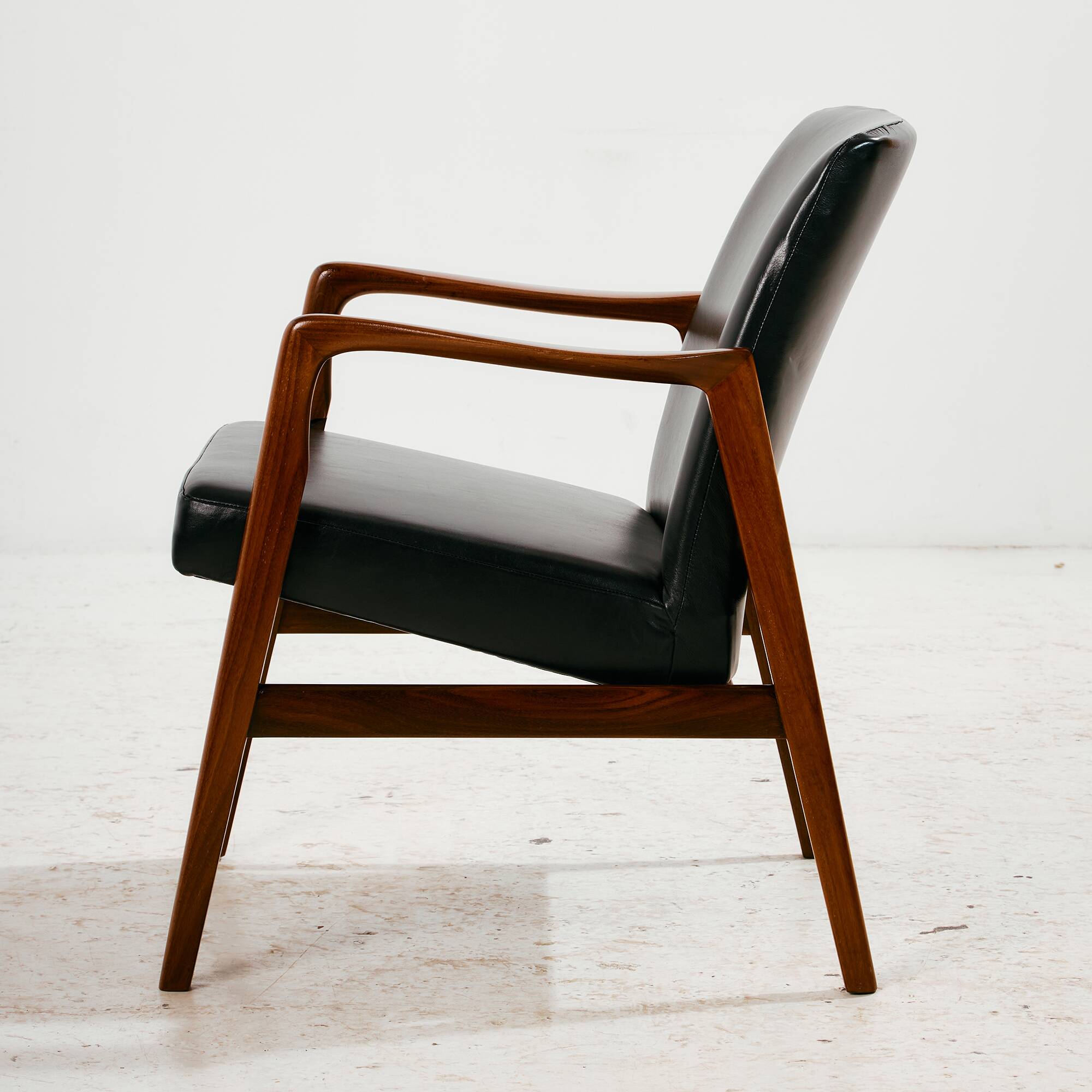 Teak armchair with leather upholstery