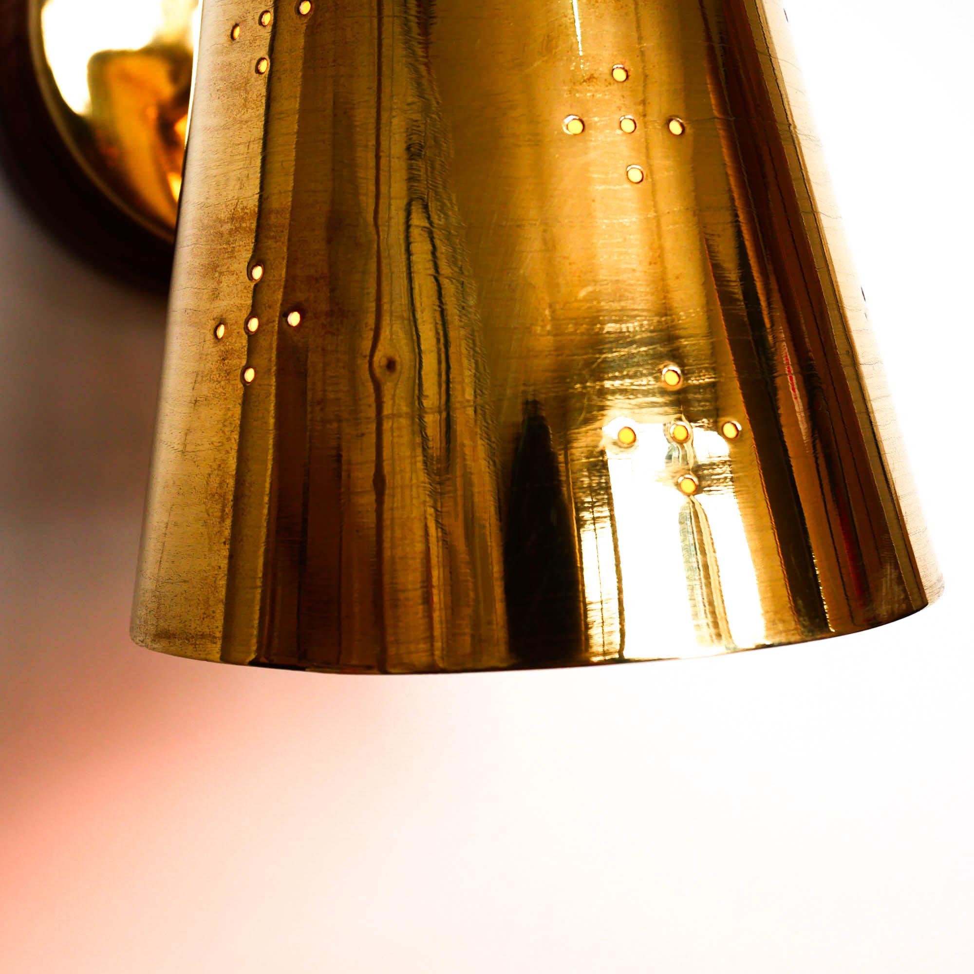Old conical brass wall lamp, perforated lampshade
