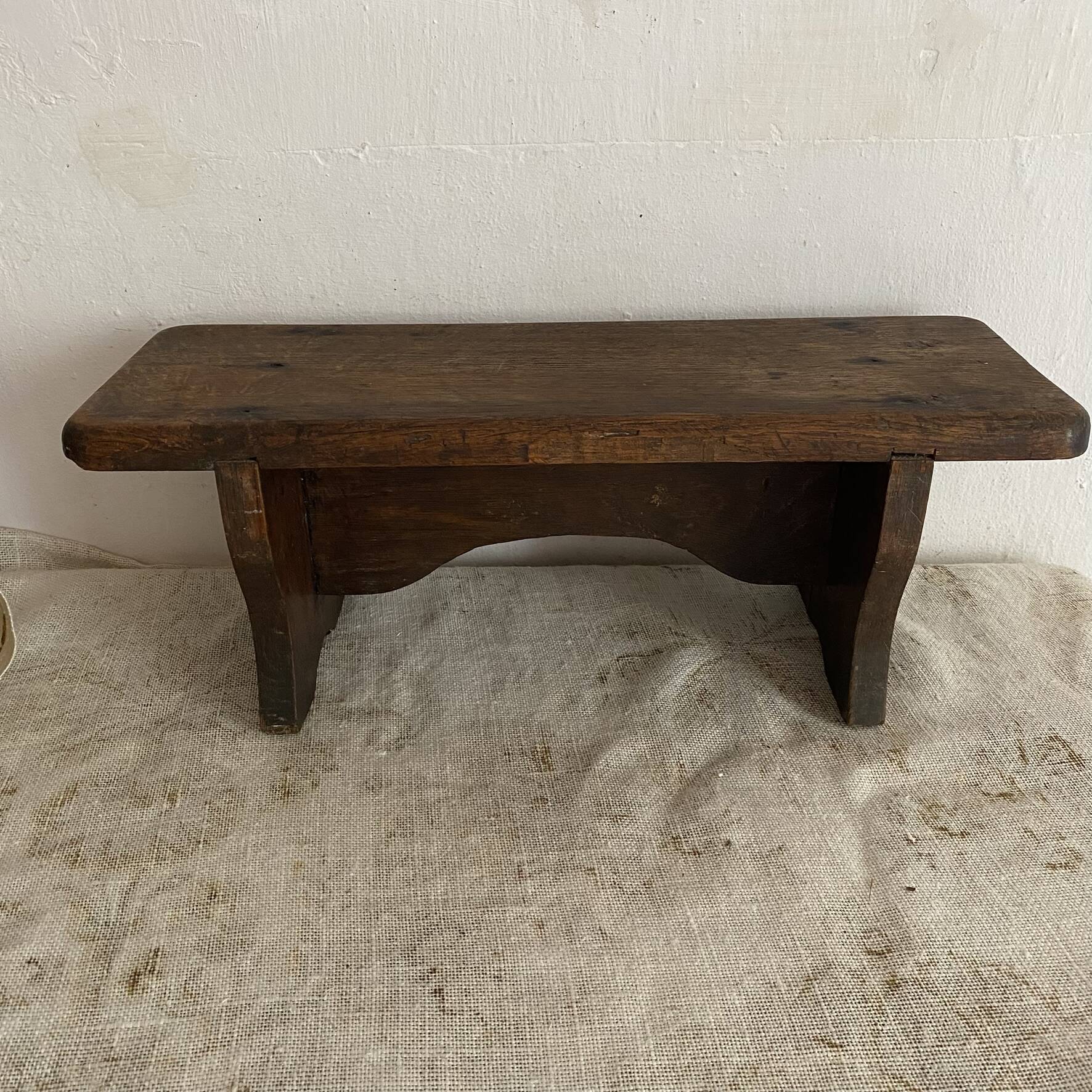 Old low stool made of solid wood