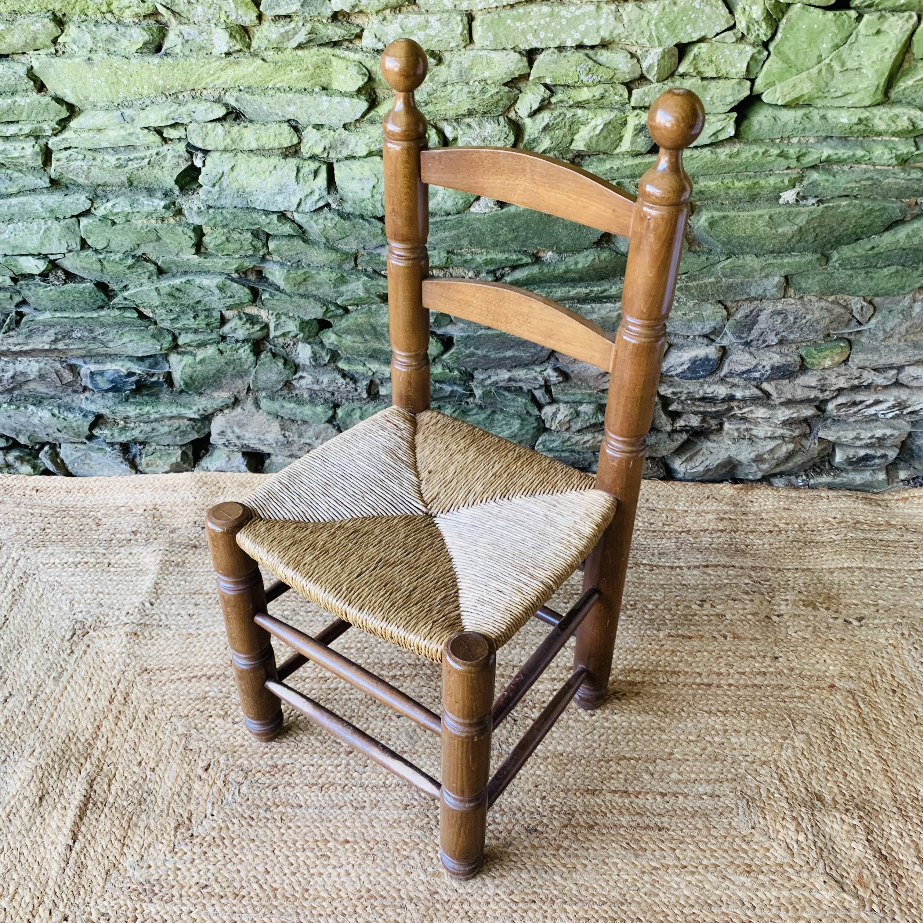 Set of 4 solid wood chairs with straw seats.