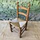 Set of 4 solid wood chairs with straw seats.