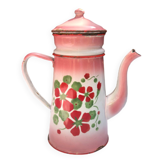 Old pink and white enameled sheet metal coffee maker with floral decoration