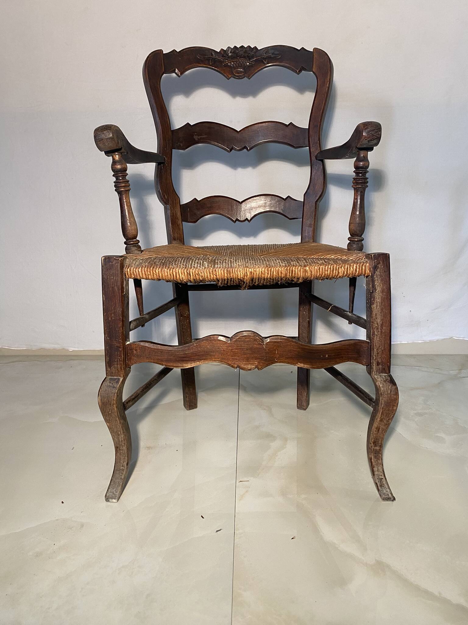 Antique Provencal armchair in carved wood with straw seat