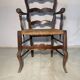 Antique Provencal armchair in carved wood with straw seat