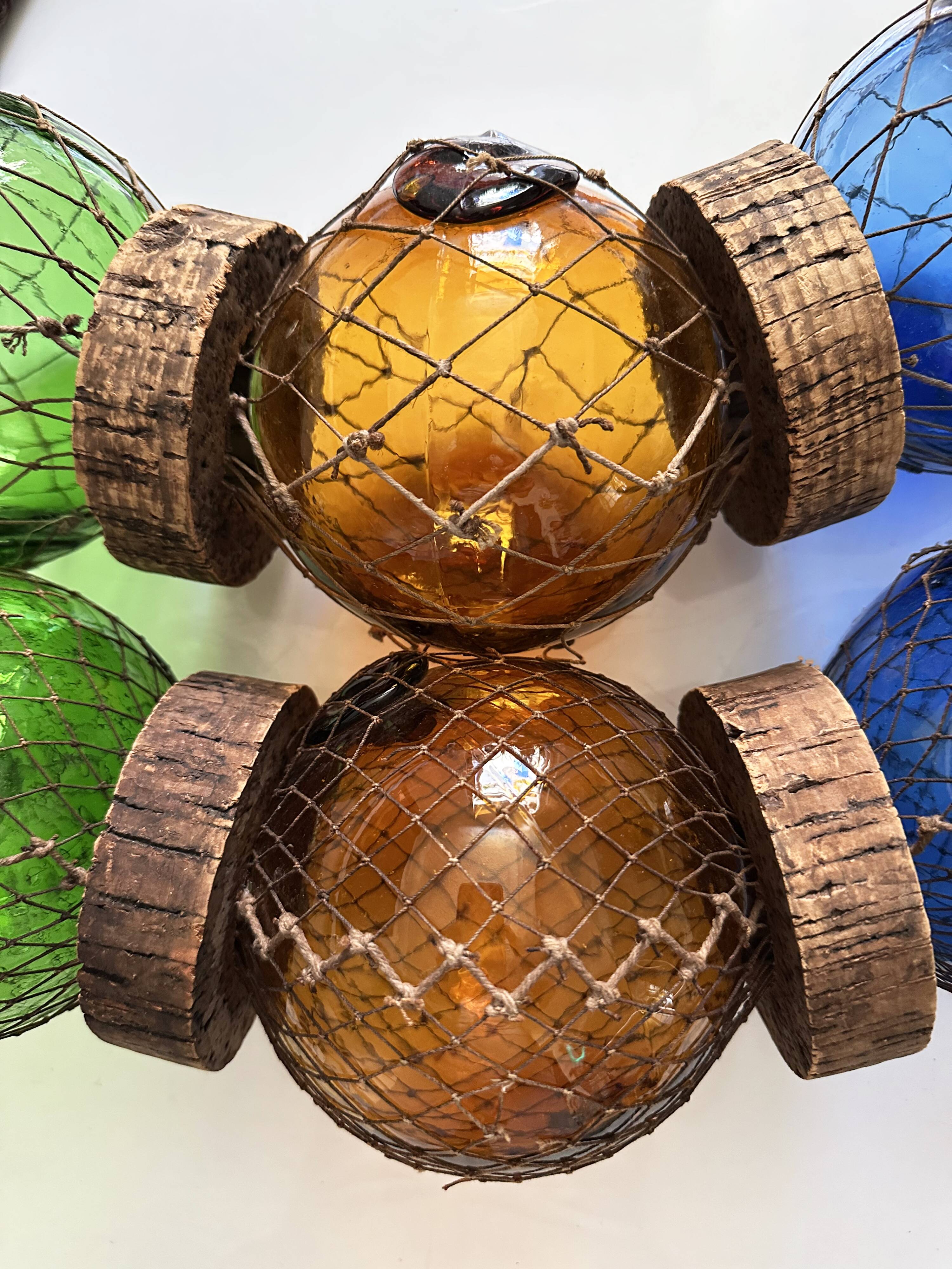 Fishing floats made of blown glass, cork, and rope. France, 1960s.