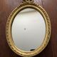 Oval wall mirror in baroque gilded plaster frame 29x20cm