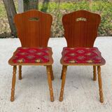 2 curved wood and red fabric chairs