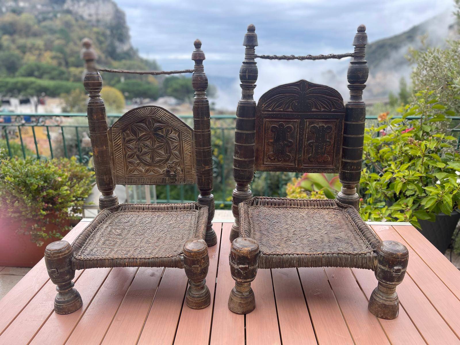 Pair of antique traditional Indian carved wooden chairs