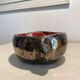 Deep red glazed and metallic ceramic catchall.