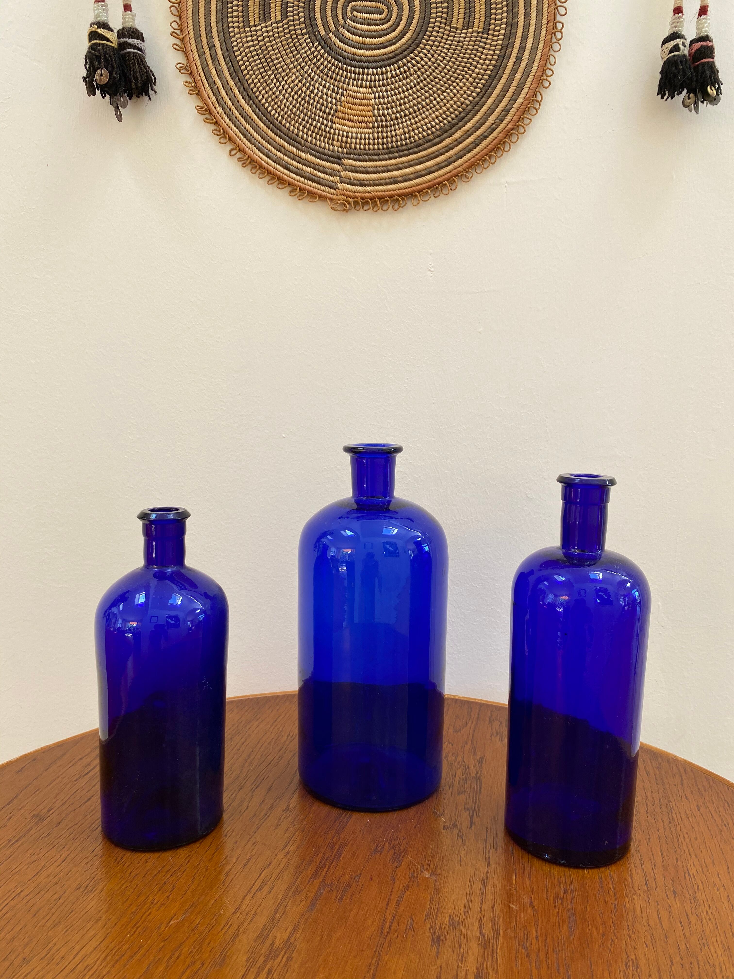 Trio of apothecary bottles in cobalt blue glass