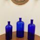 Trio of apothecary bottles in cobalt blue glass