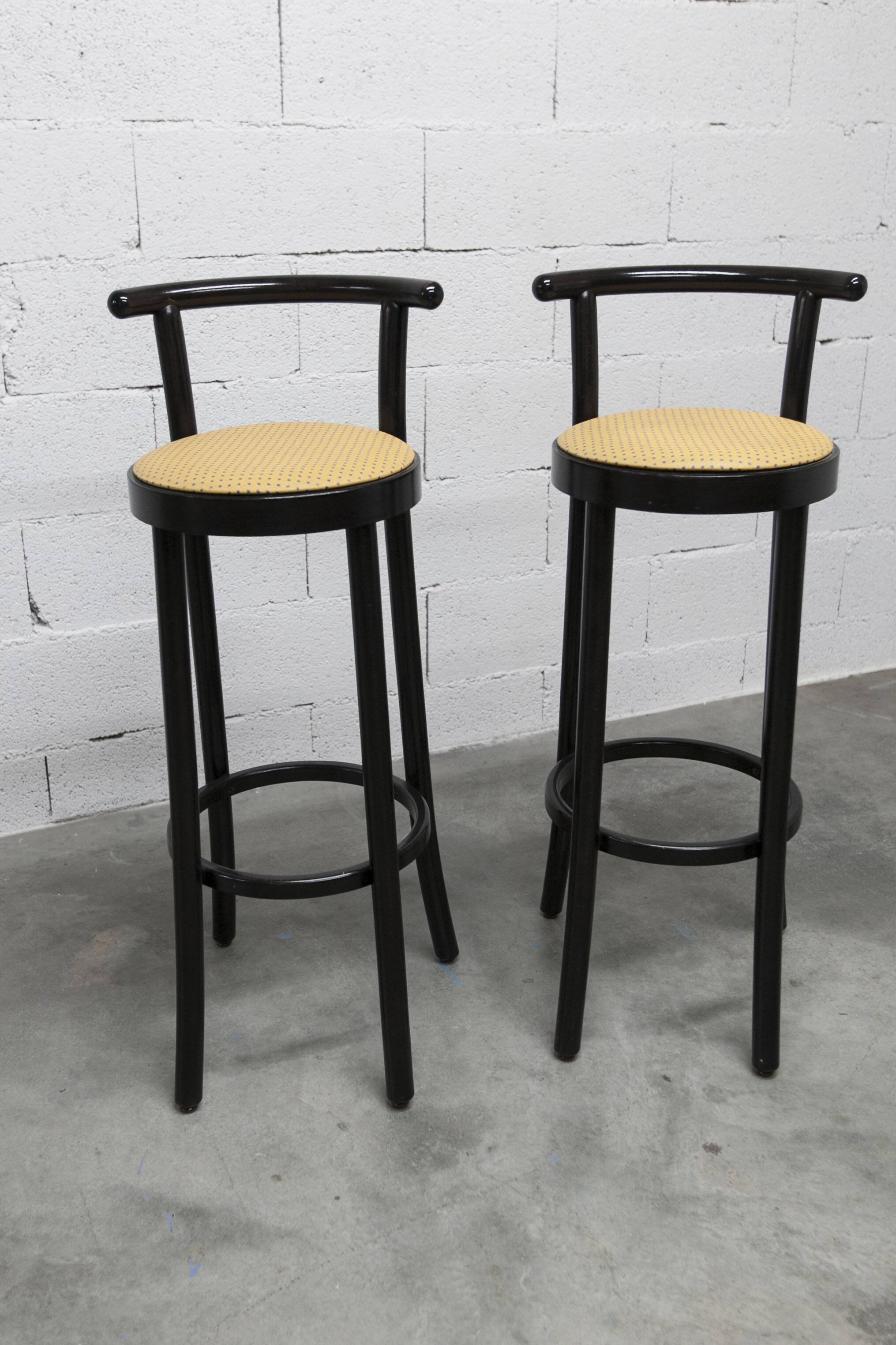 Pair of Baumann Dialog model stools in black and yellow and blue imitation leather, 1990