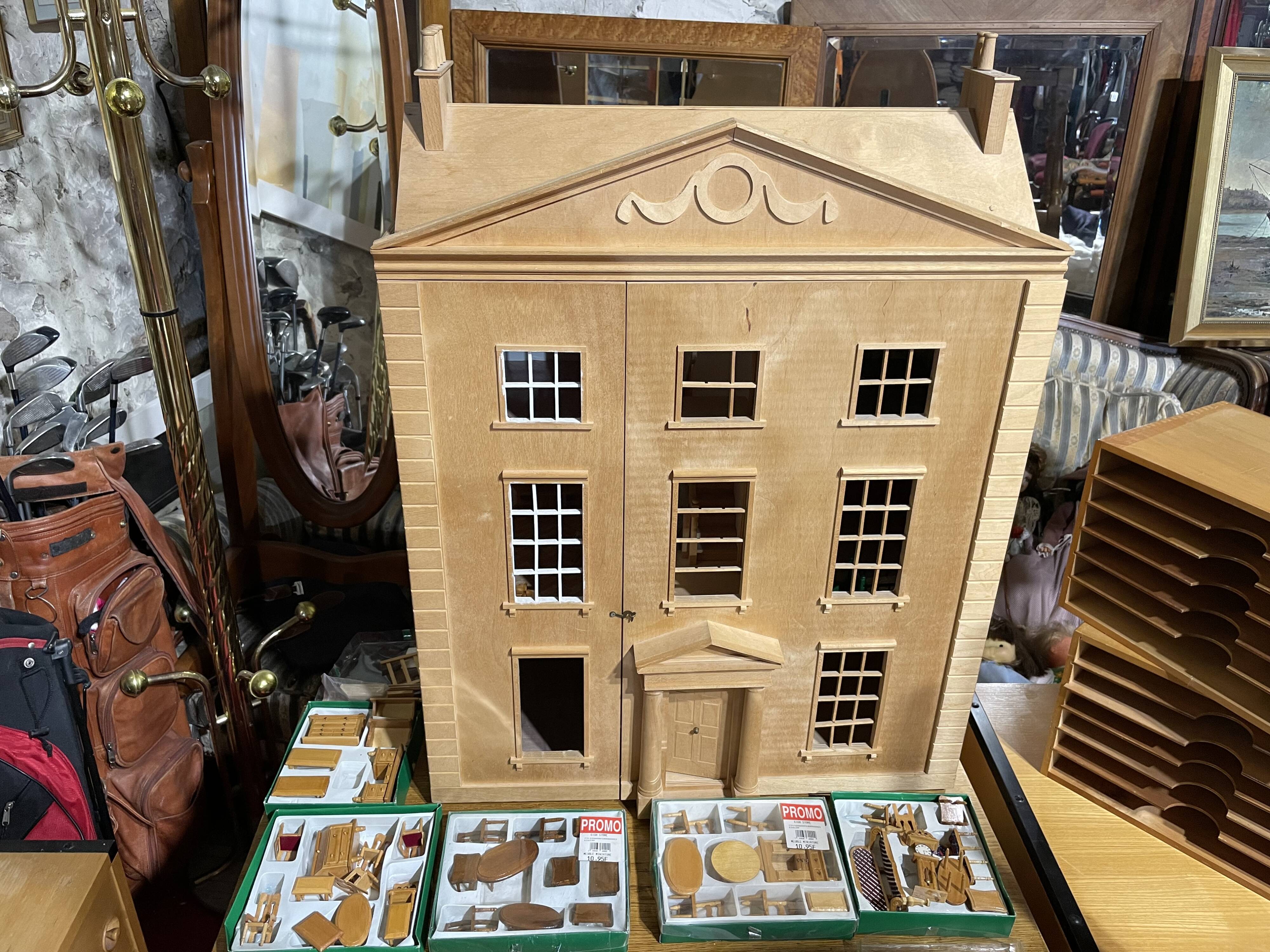 Large wooden dollhouse with miniature furniture