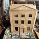 Large wooden dollhouse with miniature furniture