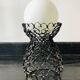 Handcrafted wrought iron lamp with a white opaline globe.