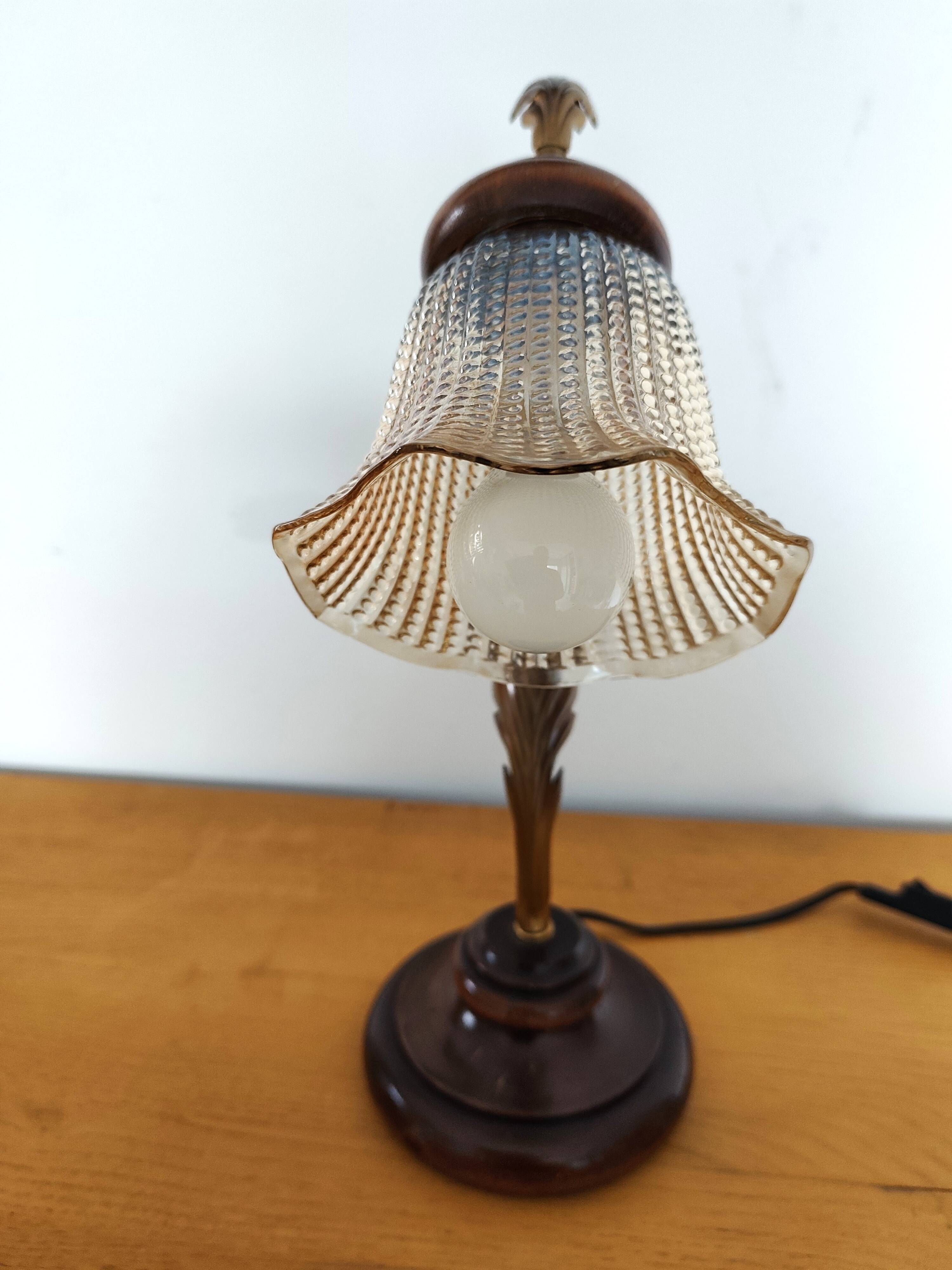 Gold swan neck table lamp with amber tulip glass.